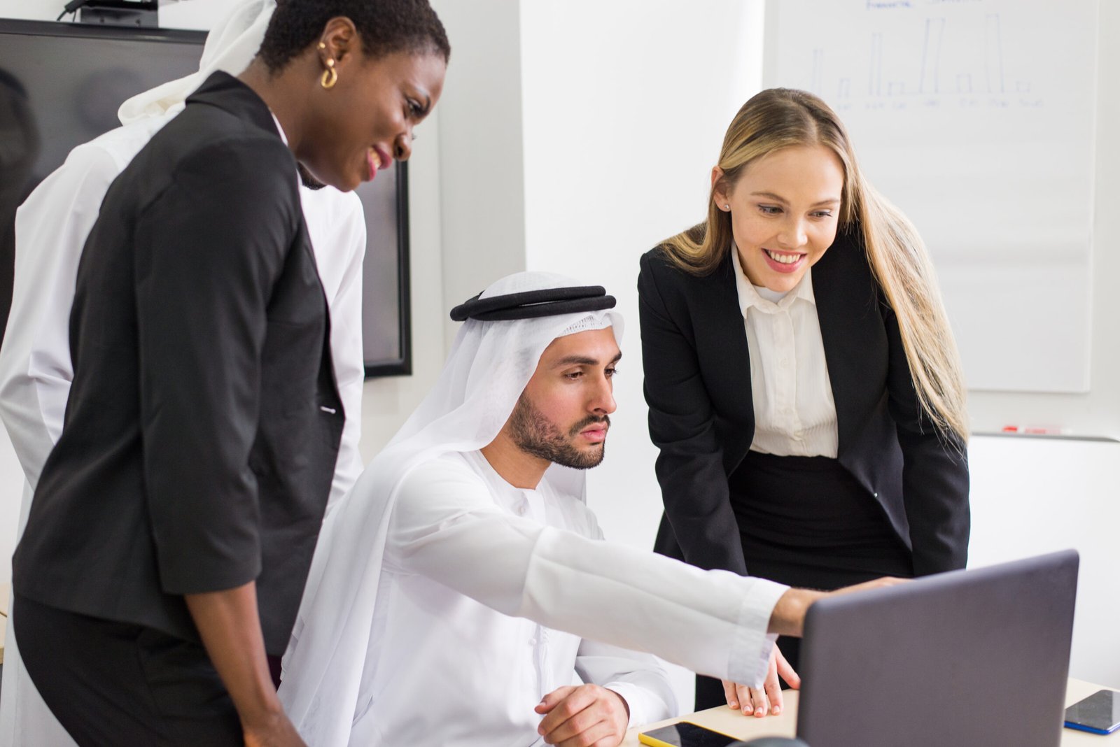 Multiracial group of business people having a meeting in a office - Teamwork in the office, business meeting in the UAE